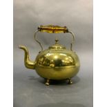 A Victorian brass toddy kettle with amber glass handle