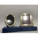 Two modern silver photograph frames, oval and rectangular, boxed