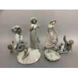 A collection of Nao figures including Edwardian girls, ballerina, child in a cradle, children having