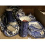 Willow pattern meat plate, tureen, pair of sauce boats together with a blue and white table lamp,