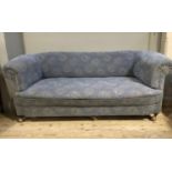 An early 20th century Chesterfield sofa having a rolled back and arms, upholstered in the original