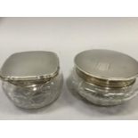 Two cut glass pin jars with silver tops, Sheffield 1940 and Birmingham 1958