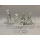 A set of six cut glass hock glasses and four various decanters and a silver port label