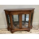 A mahogany and glazed four door display cabinet on shaped bracket feet with lights