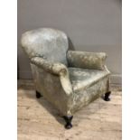 An early 20th century upholstered armchair having a rounded back and on short cabriole legs with pad