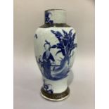 A Chinese crackle glaze baluster vase painted in blue with figures in a garden landscape