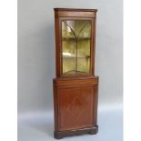 A mahogany and glazed standing corner cupboard, inlaid with boxwood and ebony chequered banding,