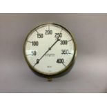 A brass cased pressure gauge by Budenberg, Broad Heath Manchester, circular, diameter 34cm