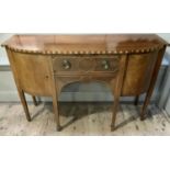 An early 19th century semi bow front sideboard, cross banded and with boxwood line inlay, having a