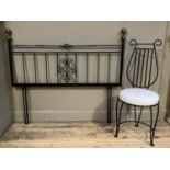 A black wrought iron bedroom chair with lyre shaped back and white cushion seat and a double