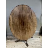 A 19th century mahogany oval tilt top breakfast table on turned pedestal with four cabriole legs,