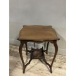 An Edwardian mahogany window table of square serpentine outline with under tier