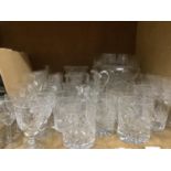 A quantity of glassware including cut and moulded fruit bowls, vases, water jugs and table glass