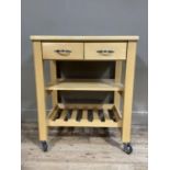 A kitchen stand on castors having two drawers above railed rack and wine rack below
