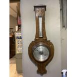 An Art Nouveau oak barometer, inlaid in mother-of-pearl and copper 88cm high