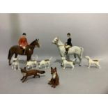 A Beswick hunting group comprising huntsman and hunt lady, five hounds and a running fox and a