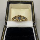 A George V sapphire and diamond five stone ring in 18ct gold, the graduated circular facetted