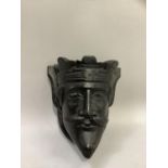 An ebonised oak carved bust of a bearded King mounted on a shield, approximately 18cm high x 17cm
