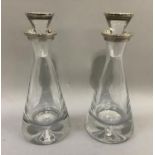 A pair of silver topped decanters, by W.I Broadway & Co each of conical form with silver topped
