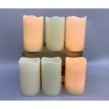 A set of six large faux candle lamps with battery lights