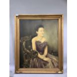 A three-quarter portrait of a lady in eveningwear sitting on a dolphin carved chair, signed C