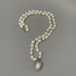 A fresh water cultured pearl and cubic zirconia necklace in silver with a simulated pearl and