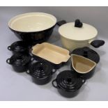 A set of five Le Creuset ceramic two-handled dishes, 22.5cm over handles and four Le Creuset ceramic