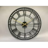 A black and gilt skeletal wall clock with Roman numerals, 82cm diameter