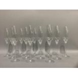 A set of twelve Royal Doulton crystal champagne glasses, cut and edged with a entwined ribbon design