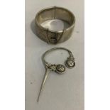 A silver stiff hinged bangle c.1961 with foliate scroll engraved front, approximate width 22mm