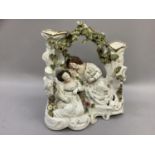 A 19th century Staffordshire figure group of babes in the wood beneath a leafy bough supported by