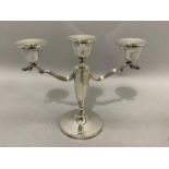 A silver three branch candelabra with C scroll arms and weighted base, approximate height 20cm