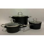 A set of Fissler cast iron cookware including a two-handled cast iron casserole with domed glass