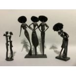 Three metal sculptures of figure groups including three elegant ladies in large brimmed hats 26cm