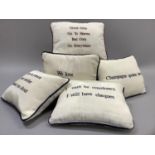 Five cream moire sick cushions each with an embroidered message