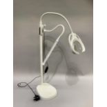 A craft or reading lamp with magnifying glass and additional strip light