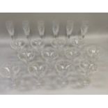 A suite of twelve Waterford Champagne coupes and six matching flutes, measuring 16cm and 26cm high