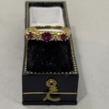 A ruby and diamond five stone ring, the circular facetted rubies and small eight cut diamonds claw