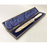 A Victorian bread knife with silver blade and mother of pearl handle, foliate engraved and