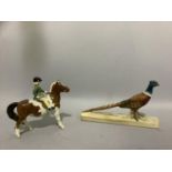 A Beswick brown and white pony with rider and a pheasant on rectangular plinth