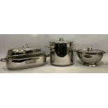 A stainless steel fish kettle, circular pedestal dish with cover and large cooking pot with cover by