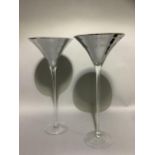 A pair of silvered and cleat glass outsize cocktail glasses, 70cm high x 32cm diameter