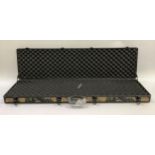 A gun case in Woodland Oak Camo with form lining and foam over centre locking clips together with