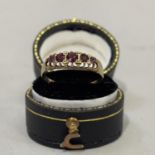 An Edward VII pyrope garnet five stone ring in 9ct gold, the graduated circular facetted stones claw