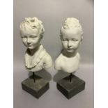 A pair of parian effect head and shoulder busts of young girl and boy, overall height 51cm