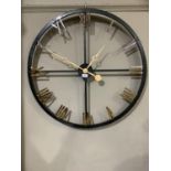 A black and gilt skeletal wall clock with Roman numerals, 82cm diameter