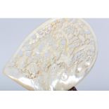A Chinese mother-of-pearl shell, carved and pierced with egrets, pine tree and peony,