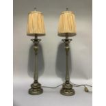 A pair of silvered leaf capped table lamps with champagne coloured beaded shades, 84cm high x