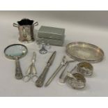 A small collection of silver plated items including a small oval gallery tray, reading glass, two