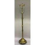 An early 20th century brass standard oil lamp having a basket top for the reservoir, telescopic
